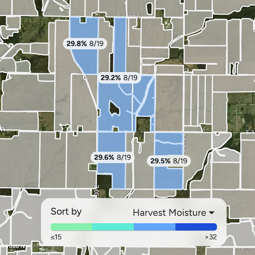 Zoomed-in AGMRI map showing several neighboring corn fields highlighted in blue, each labeled with a predicted moisture reading near 29–30% for the same date, above a Harvest Moisture color legend.